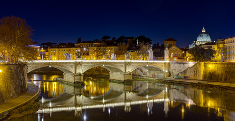 Fototapeta na wymiar Ponte Vittorio Emanuele II and Tiber river by night, St. Peter basilica in the background, Rome, Italy.