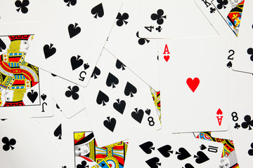 Red heart card difference on black spade and club poker background