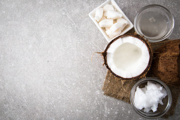Fototapeta na wymiar Coconut with coconut oil in jar on wooden background