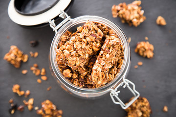 Healthy breakfast. Fresh granola, muesli in a glass jar. copy space.Organic oat,almond and cherry