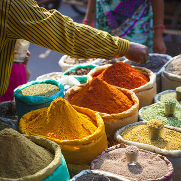 Colorful spices powders and herbs in traditional street market in Delhi. India.