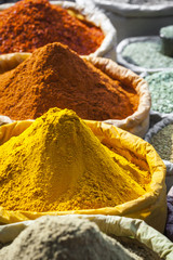 Colorful spices powders and herbs in traditional street market in Delhi. India.