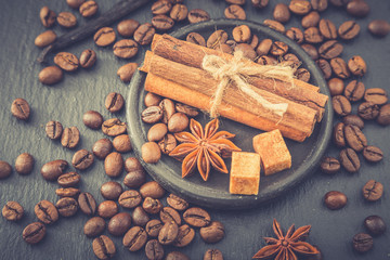 Roasted coffee beans background. Coffee beans with copy space for text. Seasoning. Spice. Cinnamon. Badian. Vanilla