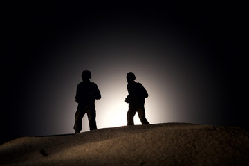 Fototapeta na wymiar Silhouette of soldiers on a dark background