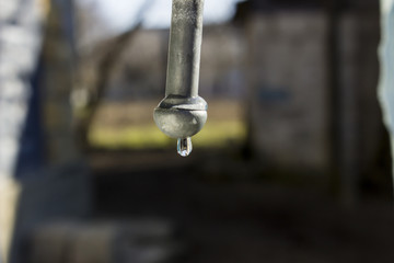 Drop water hanging at the tip of the iron rod