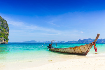 Naklejka na ściany i meble Thailand summer travel sea, Thai old wood boat at sea beach Krabi Phi Phi Island Phuket park on white sand blue sky emerald green ocean water.