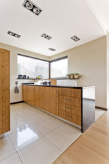 Fototapeta na wymiar Bright kitchen with wooden furniture