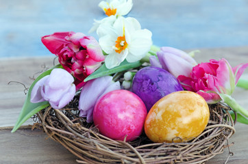 Happy Easter: nest with Easter eggs, feathers, tulips and daffodils:)
 