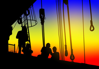 Silhouettes of workers at a construction site