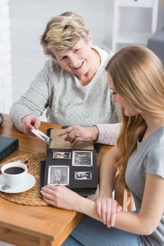 Grandma showing photos to her dranddaughter