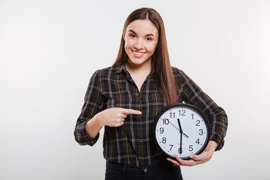 Smiling Woman in shirt holding the clock