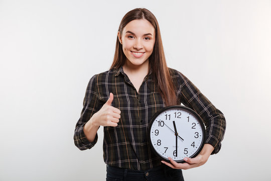 Happy Woman in shirt holding the clock