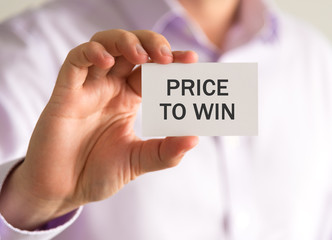 Businessman holding a card with PRICE TO WIN message