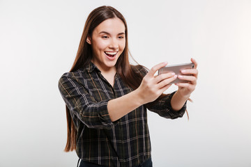 Fototapeta premium Happy Woman in shirt playing on phone