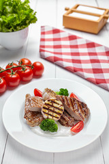 Assorted Meat Grill. Delicious fried pieces of beef medium rare and appetizing pieces of pork. Close up