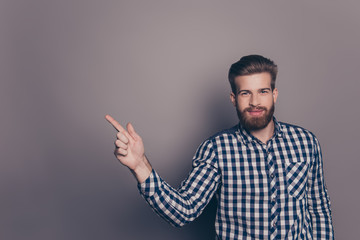 Fototapeta premium Portrait of a smiling bearded man pointing finger away