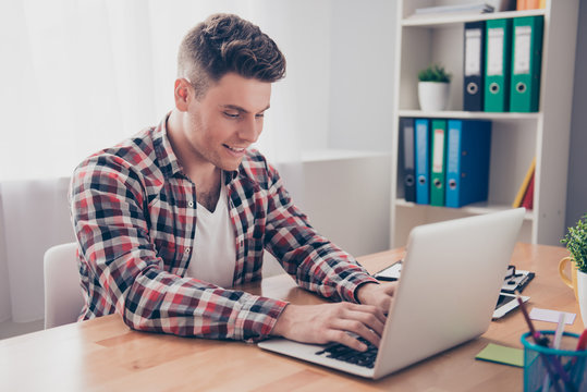 Happy smiling guy  chatting on the Internet