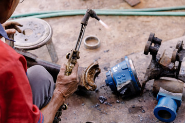 Fototapeta na wymiar Asians Craftsman being using gas welding steel in a factory