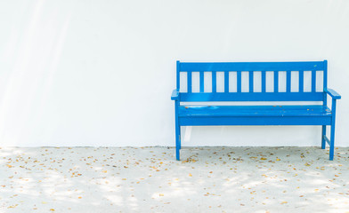 blue bench with white wall