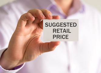 Businessman holding a card with SUGGESTED RETAIL PRICE message