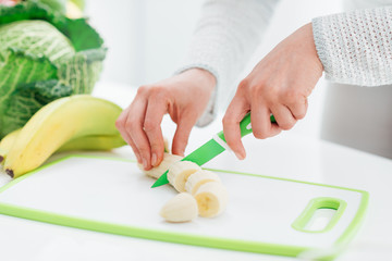 Woman slicing a banana