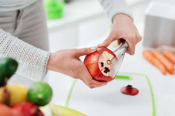 Woman preparing a pomegranate