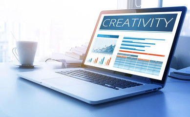 Creativity text on aptop screen with graph chart background.business marketing,success and goals concept. - Powered by Adobe