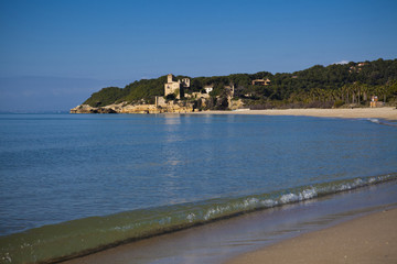 desert beach with a castle background in Tamarit, Altafulla, Tarragona, Catalonia, Spain