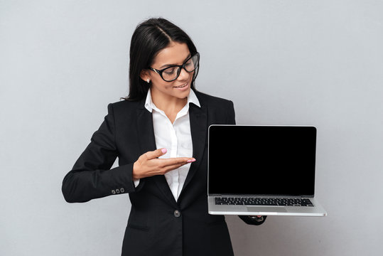 Business woman showing blank laptop screen