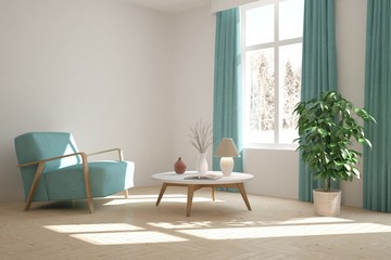 White room with armchair and winter landscape in window. Scandinavian interior design