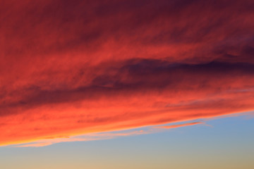 Beautiful sky background. Fiery orange dramatic sunset sky with cloud