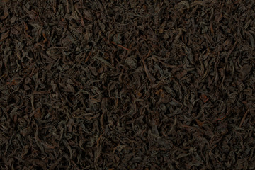 Dry black tea leaves texture background.