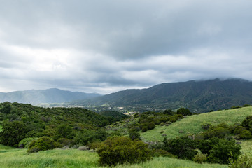 Dark clouds over a green valley.