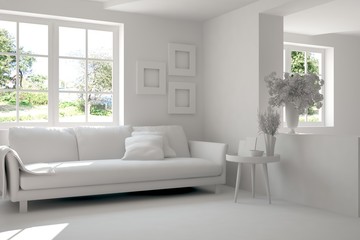 Fototapeta premium Grey room with sofa and green landscape in window. Scandinavian interior design