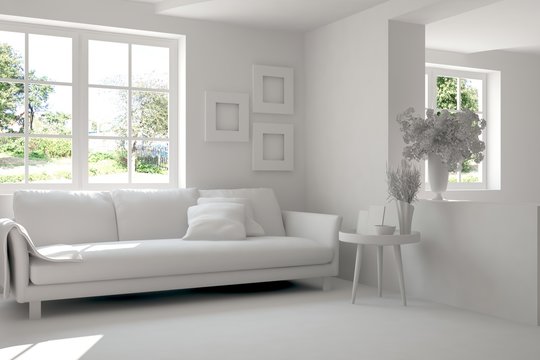 Grey room with sofa and green landscape in window. Scandinavian interior design