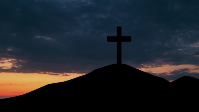 Silhouette of christian cross symbol on the mountain peak at sunset time