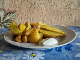 potatoes rustic. with sour cream on the plate. sliced