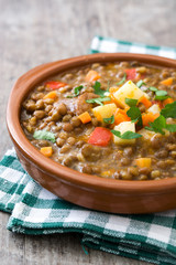 Lentil soup in a bowl on wooden background
