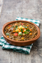 Lentil soup in a bowl on wooden background
