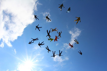 Skydivers are moving from each other.