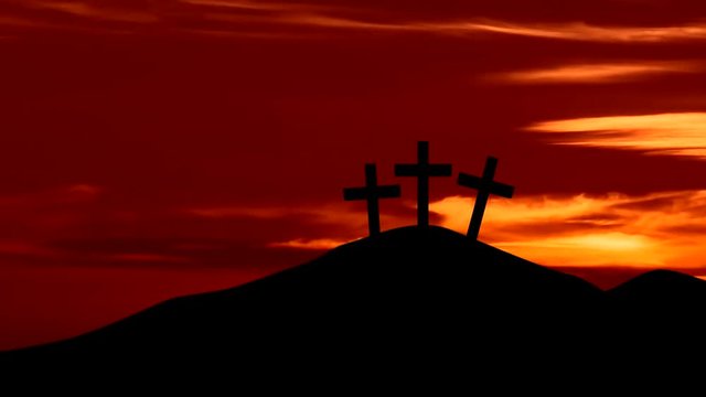 Silhouette of three christian crosses on the hill with sunrise sky