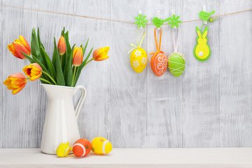 Easter eggs and colorful tulips bouquet
