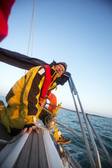 Man Cranking A Winch On Yacht In Sea