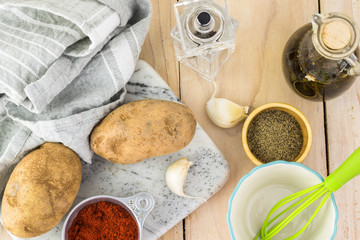 Ingredients for hasselback potatoes with smoked paprika and bacon.
