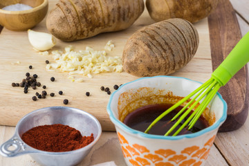 Ingredients for hasselback potatoes with smoked paprika and bacon.