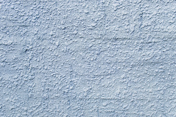 Embossed stucco grayish-bluish surface closeup. For background and texture.