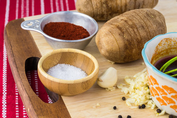 Ingredients for hasselback potatoes with smoked paprika and bacon.