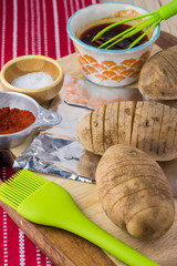 Ingredients for hasselback potatoes with smoked paprika and bacon.