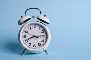Alarm clock on blue background
