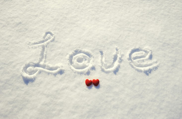 word love and red heart on snow